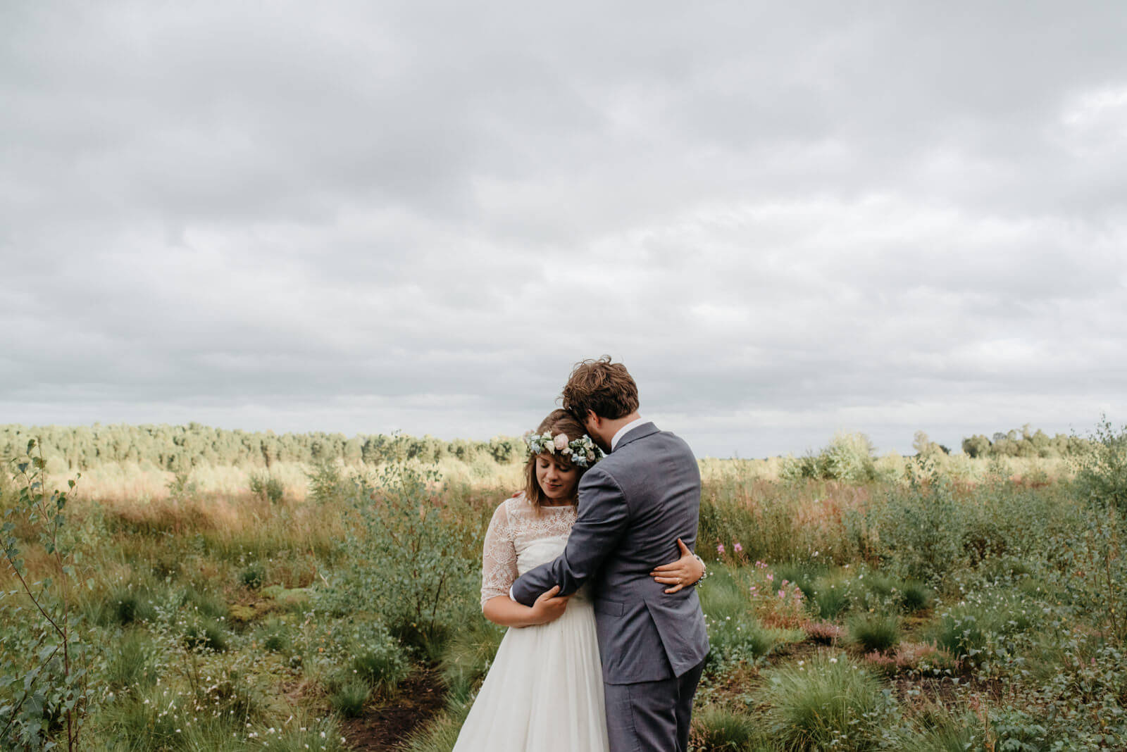 Relaxed portrait of bride and groom in beautiful landscape location at Shropshire mosses