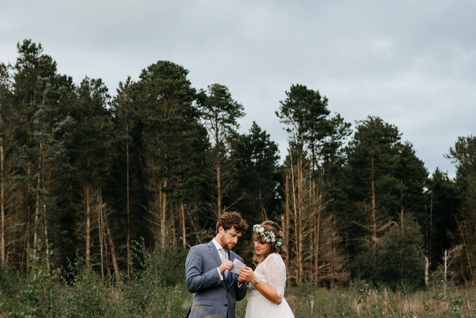 Groom sharing speech details with bride during their portrait session in Mosses Nature Reserve in Shropshire