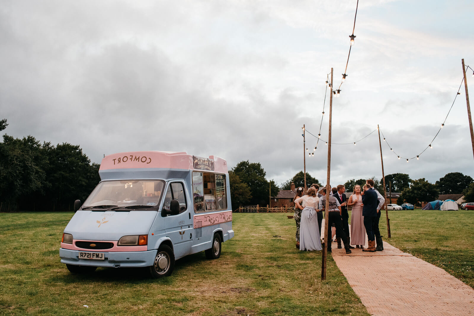 Guests congregate next ice cream van at relaxed nautral Shropshire wedding