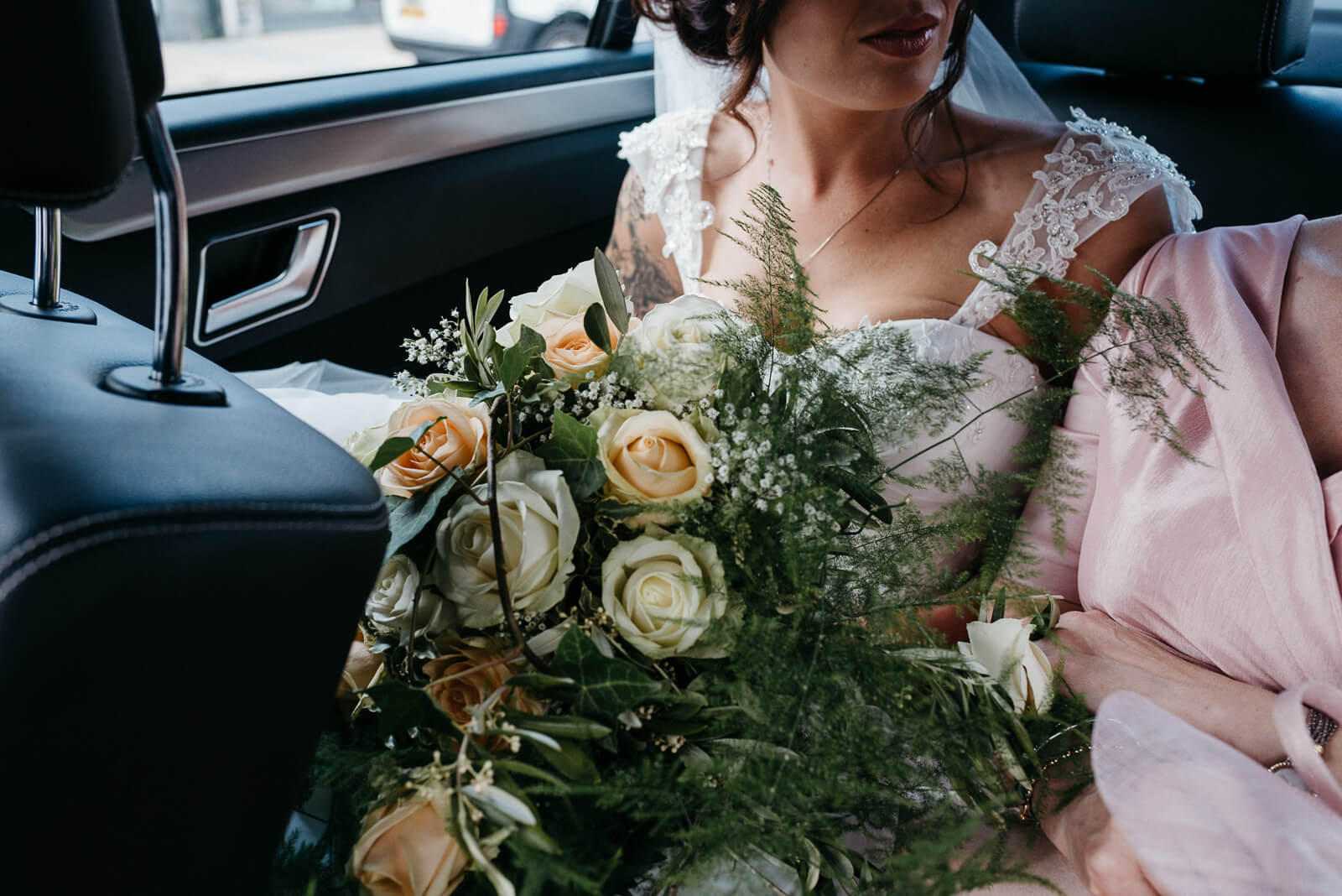 bride in car on way to her intimate city hall wedding