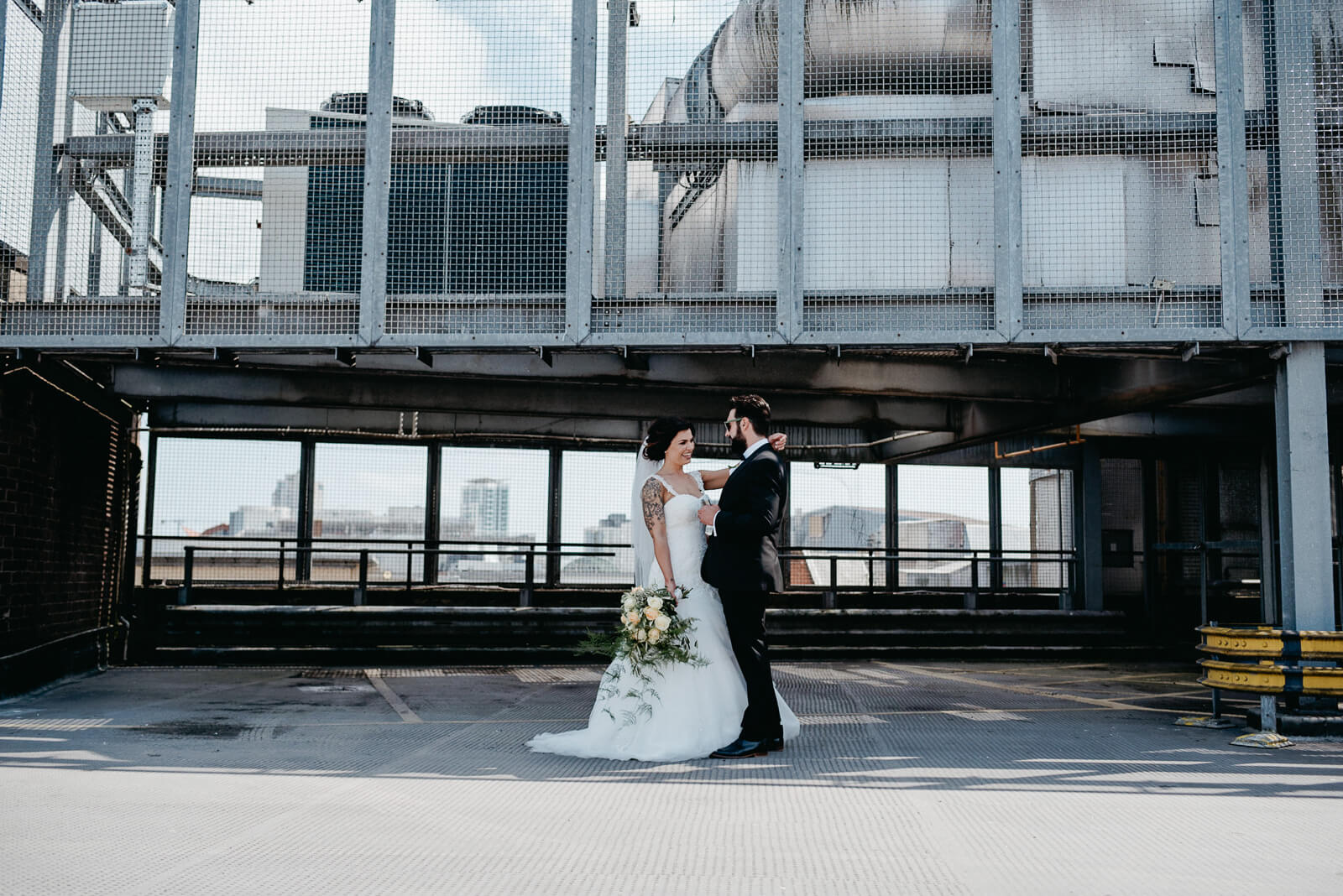 modern couple portraits on the rooftop of a carpark in the heart of the city