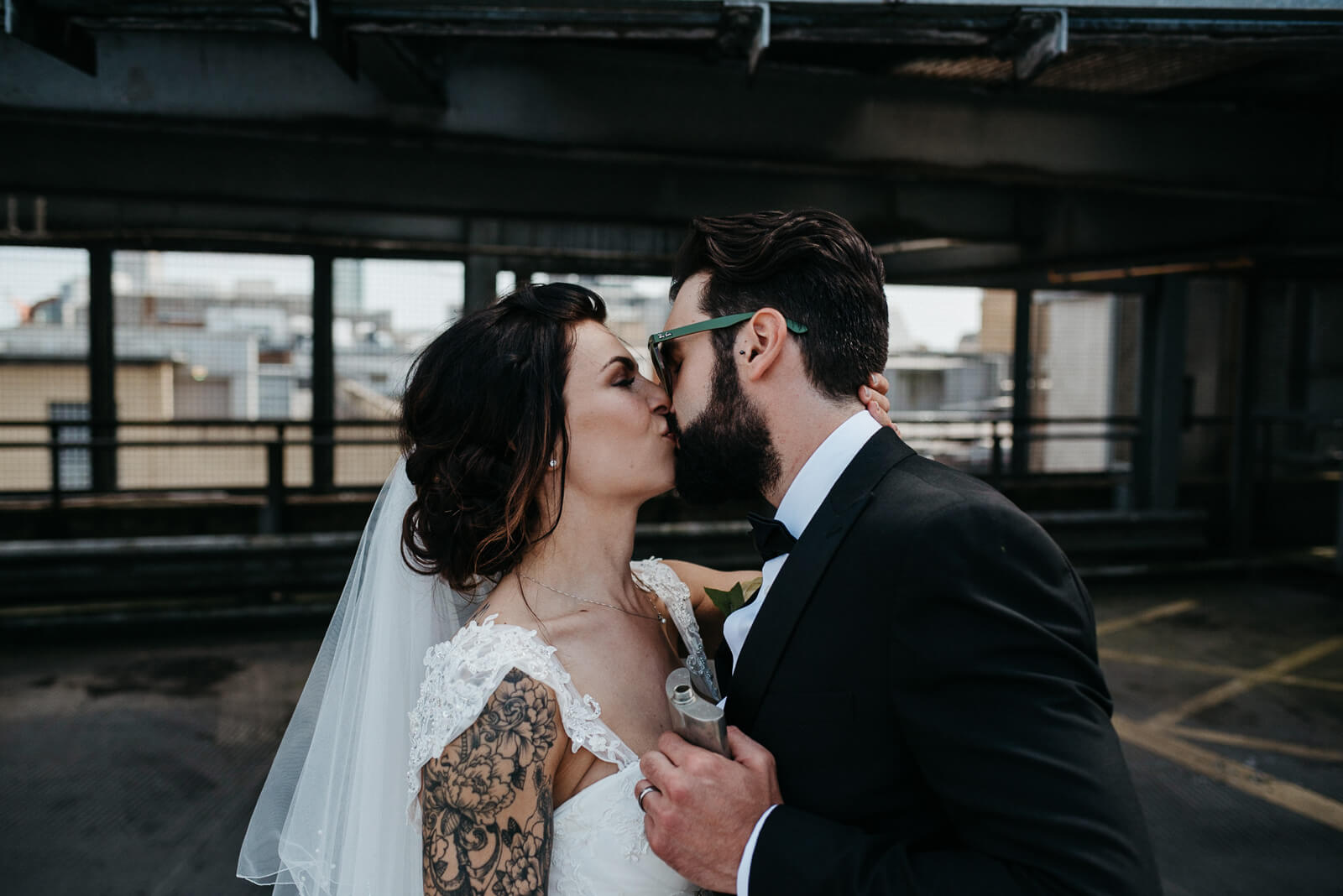 alternative cool bride and groom kissing following their city wedding with new york vibes