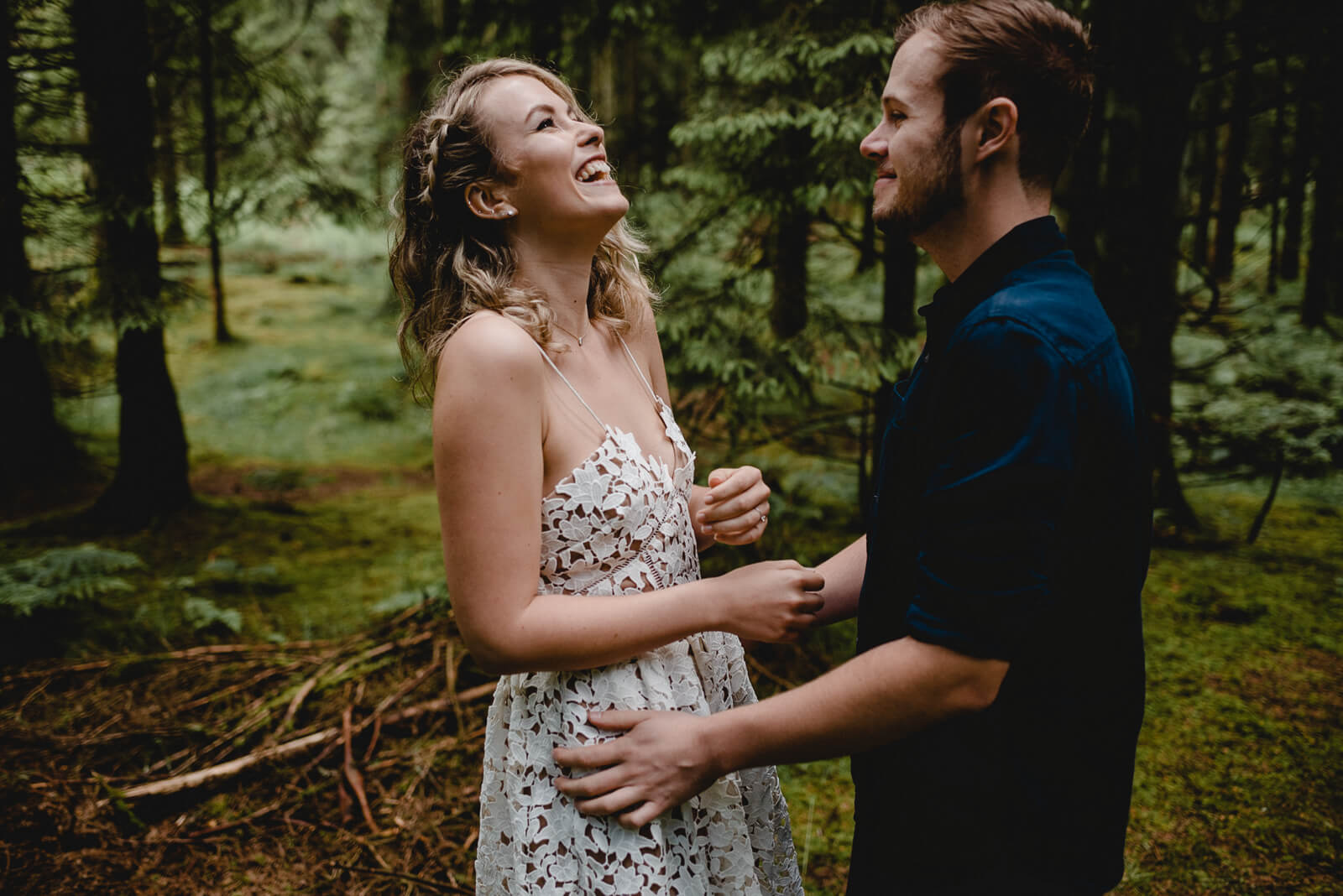 Bride & Groom sharing a joke during their woodland portraits in Somerset