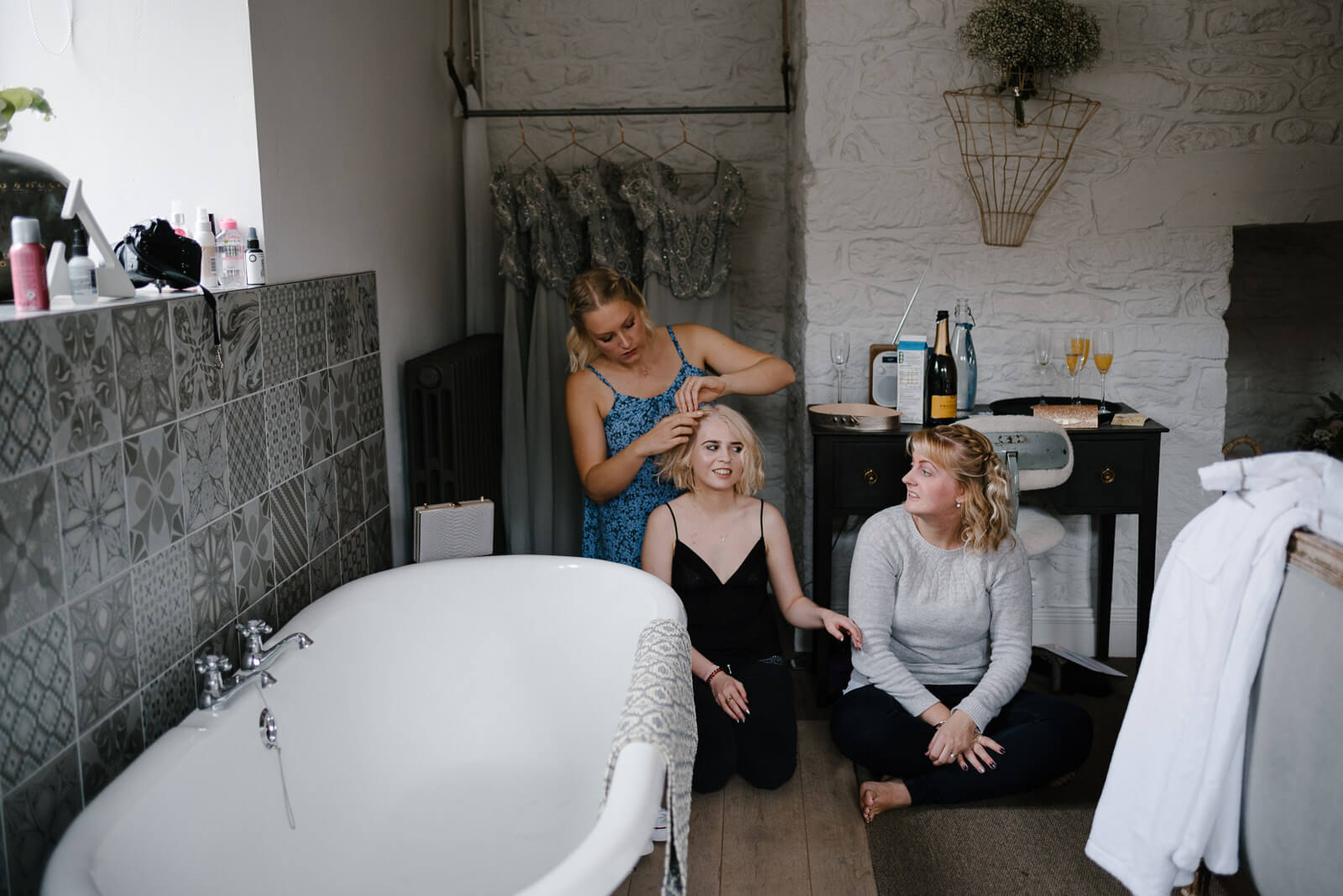 Bridesmaids chatting and doing each others hair for a Wilshire wedding