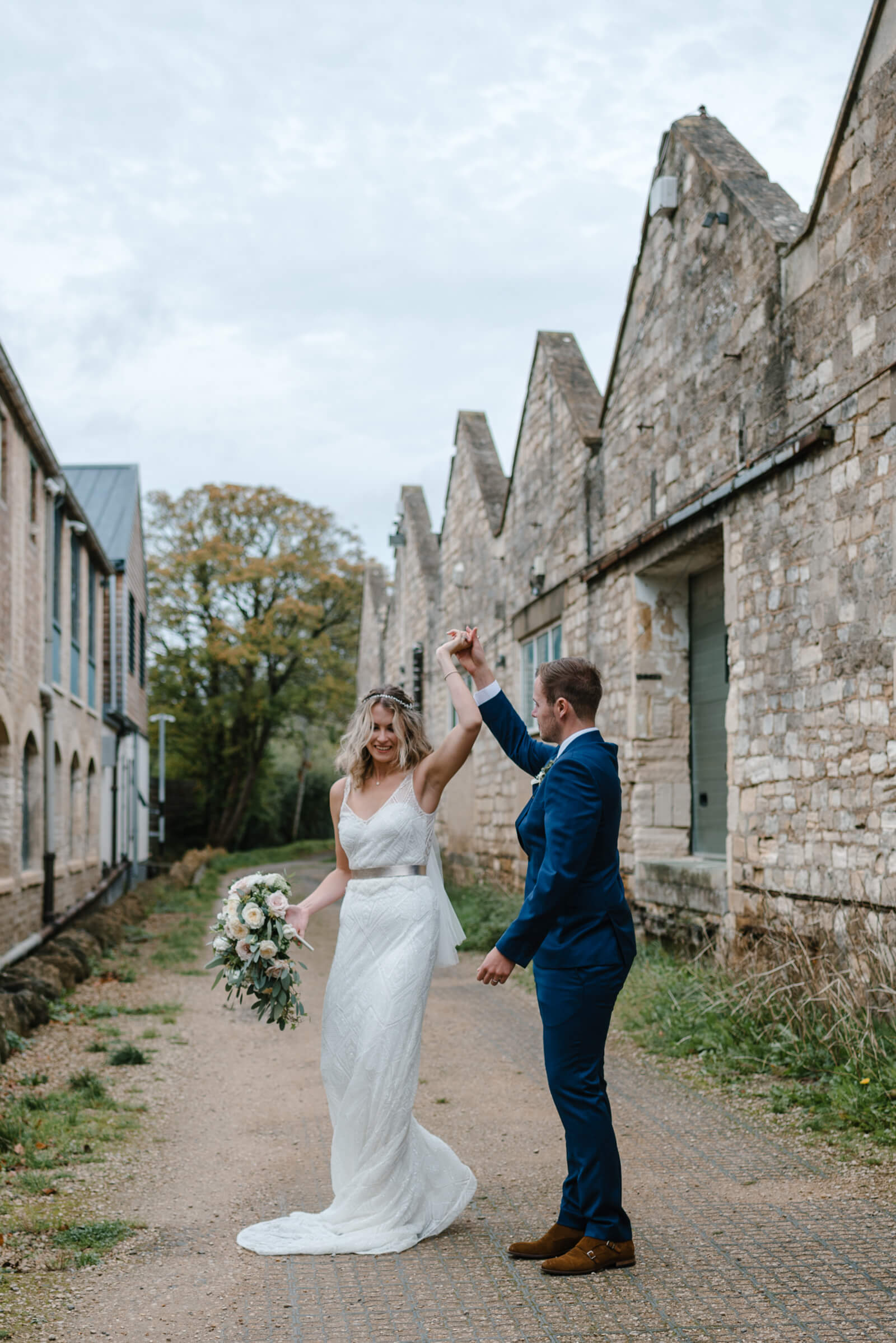 Bride and groom practicing their first dance for their Wiltshire wedding at Glove Factory Studios