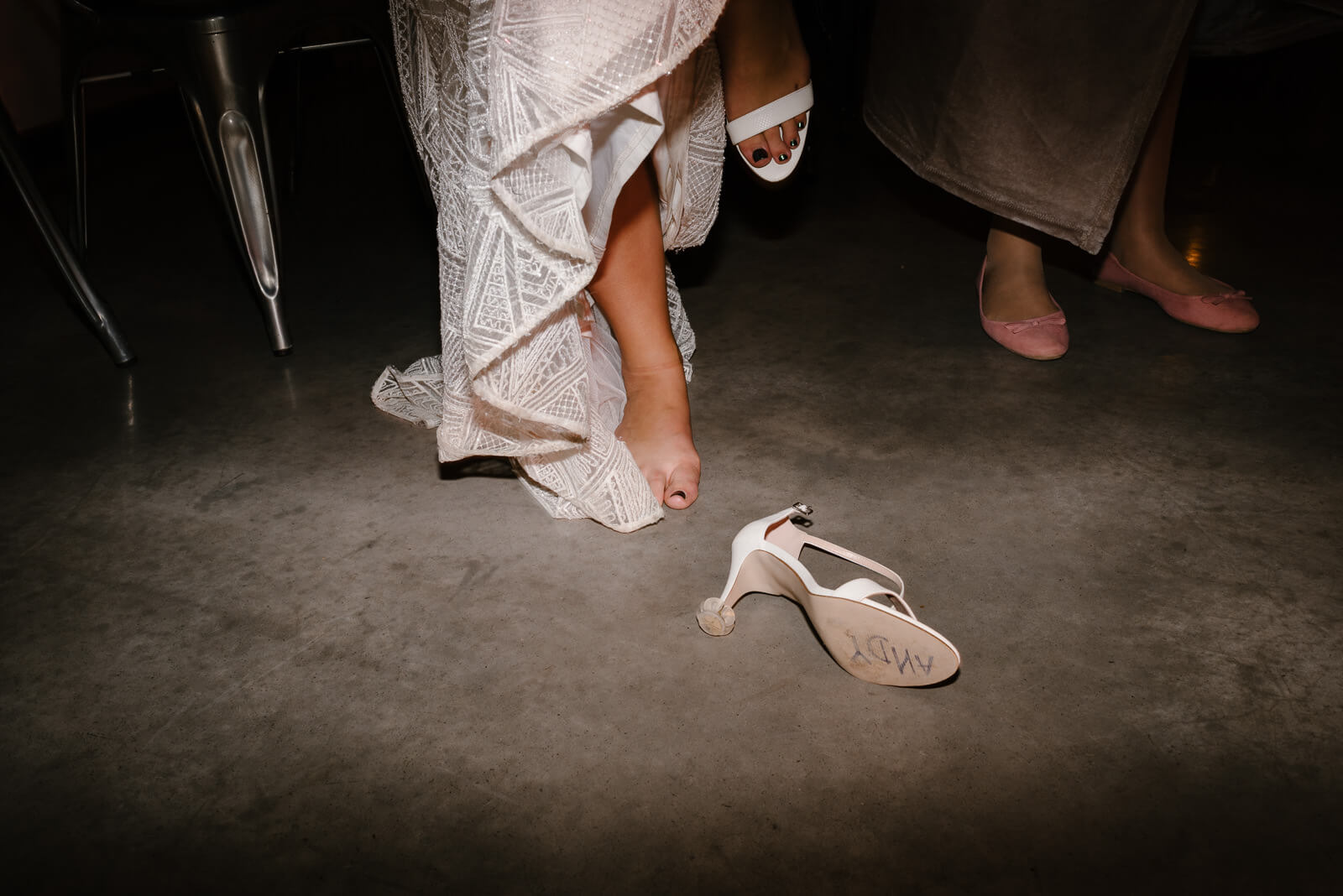 bride kicking her shoes off to dance at her wiltshire wedding