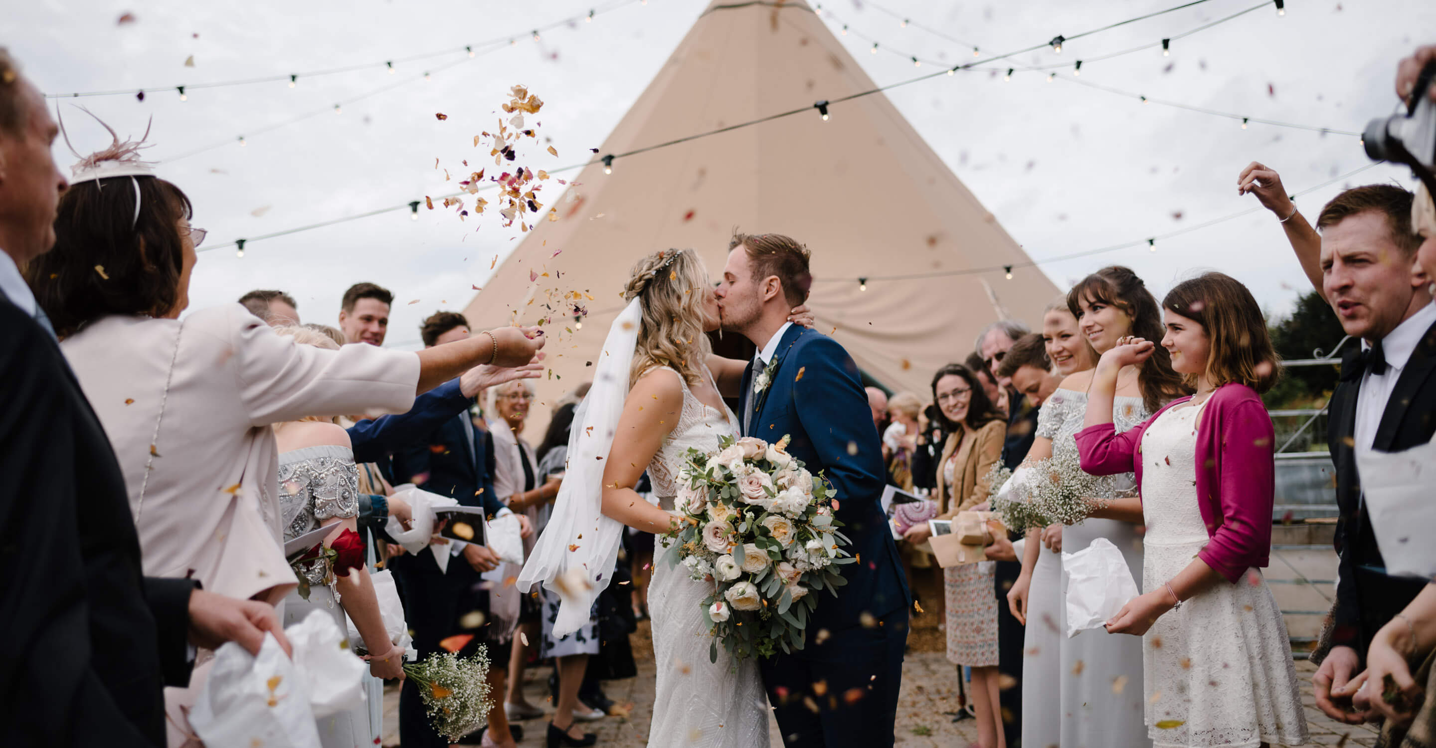 Romantic photograph of couple during confetti at South Wales Wedding