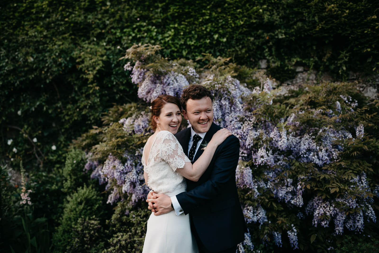 happy couple during candid portraits at Slebech Park wedding in Pembrokeshire