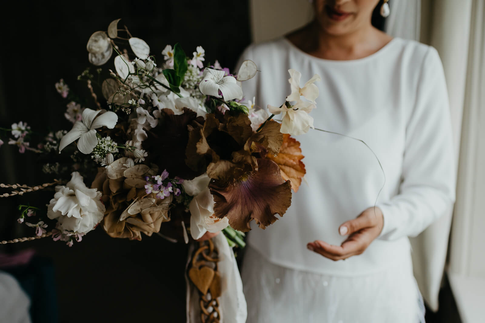 Plas Dinam Bride holds her flowers by Vervain Flowers