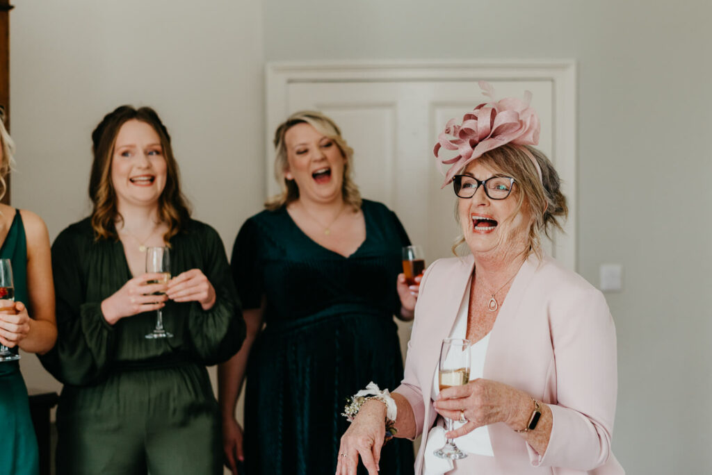 mother of the groom celebrates with the bride and bridesmaids
