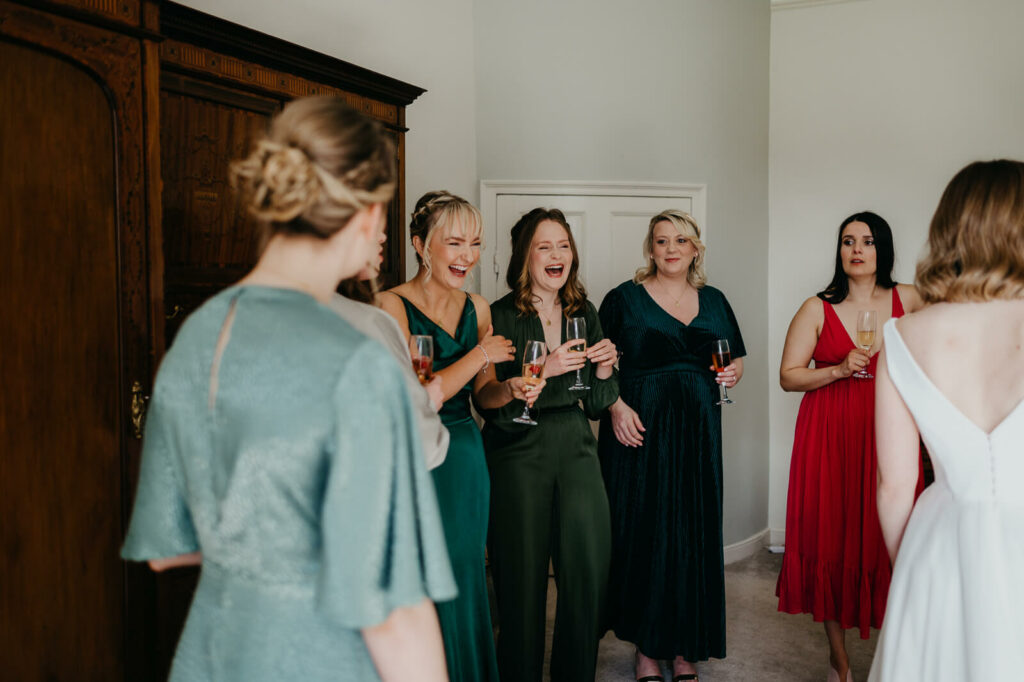 bridesmaids with champagne before setting of to the church