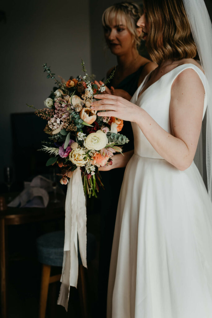 bride looks at her wedding bouquet