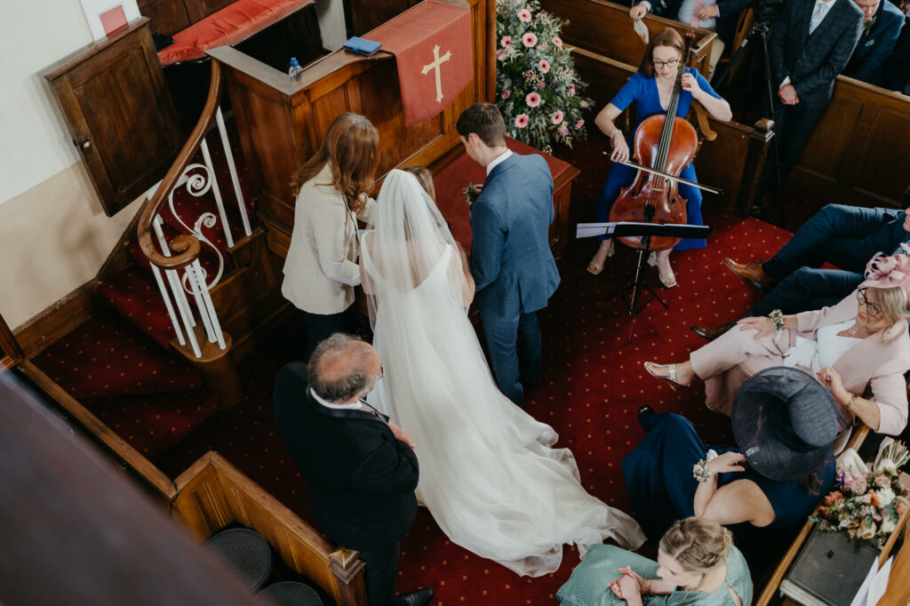 bride and groom sign register at Capel y Bedyddwyr Pen-y-Bryn